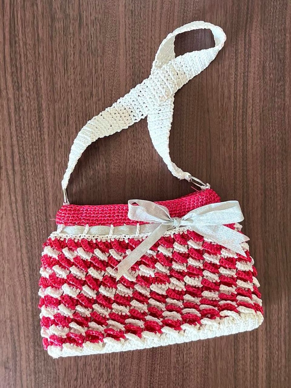 pink and white knit bag with silver bow